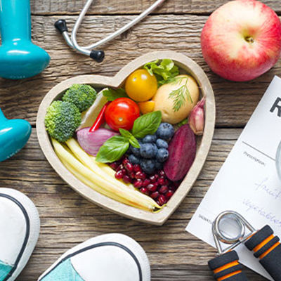 a heart shaped bowl filled with vegetables